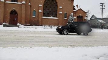cars passing by old church, winter in Canada video