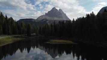 Antorno Lake and Tre Cime di Lavaredo Peaks Reflection in Italian Dolomites aerial view, Italy video