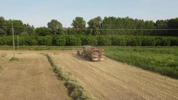 Tractor Machine Working on Hay Bales in Agriculture Field video