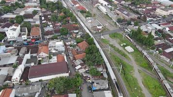 Aerial View of Passenger Train Passing by a Rail Near Solo Balapan Station in Surakarta Indonesia video