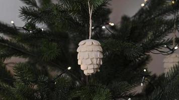 Zero waste christmas concept. Christmas tree decorated with pine cone ornaments made of natural materials. video