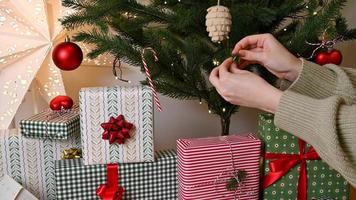 Female hands  decorate christmas tree with ornaments video