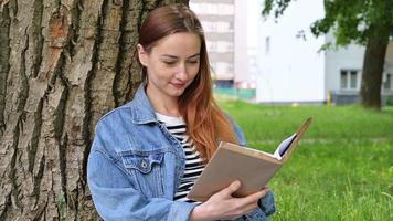 Back to school,college,university cocnept with happy woman reading book.Leisure or hobby concept video