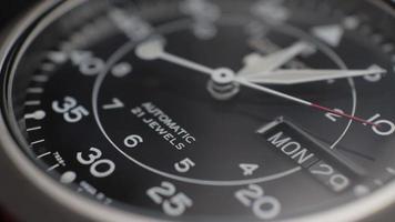 Macro close up of an automatic mechanical field watch with moving arms video