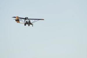 Plane flying high up in the cloudless sky at daytime. Male pilot photo