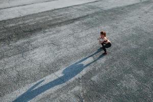 Top view of woman that have fitness day on the road at evening photo