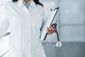 Close up view of young nurse that indoors in modern clinic. Conception of healthcare photo