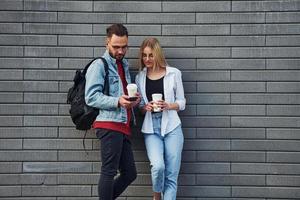 Young stylish man with woman in casual clothes outdoors together. Conception of friendship or relationships photo