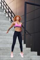 Young european redhead woman in sportive clothes outdoors photo