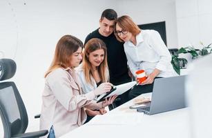 Group of business people in formal clothes indoors in the office photo