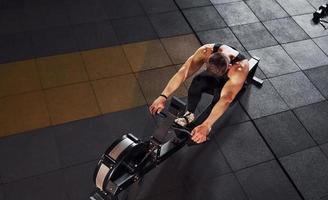 Strong man in sportive clothes have workout day in the gym photo