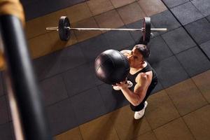 Strong man in sportive clothes have workout day in the gym photo