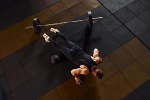 Top view of strong man in sportive clothes that have workout day in the gym photo