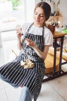 Young female ceramist indoors with handmade clay product. Conception of pottery photo