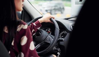 Close up view of beautiful young brunette that inside of modern automobile. Riding car photo