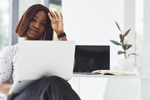 Young african american woman in formal clothes is in the office photo