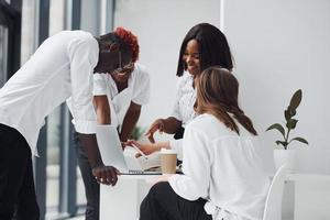 Using laptop. Group of african american business people working in office together photo