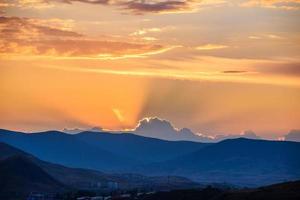 Dramatic sky over mountain silhouette photo