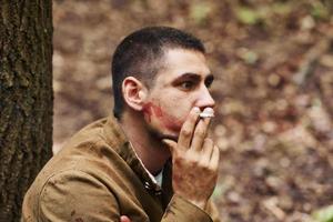 TERNOPIL, UKRAINE - June 2020 UPA Ukrainian Insurgent Army movie filming. Pictures of backstage. Soldier sitting in forest and smoking photo