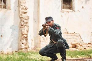 TERNOPIL, UKRAINE - June 2020 UPA Ukrainian Insurgent Army movie filming. Pictures of backstage. Young soldier with weapon near old building photo