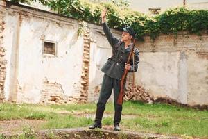 TERNOPIL, UKRAINE - June 2020 UPA Ukrainian Insurgent Army movie filming. Pictures of backstage. Young soldier with weapon near old building photo