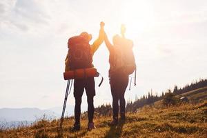 In adventure together. Cute couple. Majestic Carpathian Mountains. Beautiful landscape of untouched nature photo