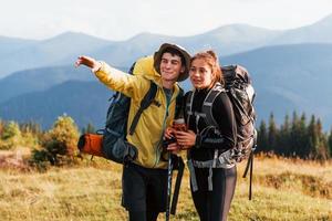 In adventure together. Cute couple. Majestic Carpathian Mountains. Beautiful landscape of untouched nature photo