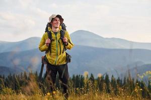 Cheerful young traveler. Majestic Carpathian Mountains. Beautiful landscape of untouched nature photo