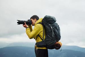 Young photographer makes photos. Majestic Carpathian Mountains. Beautiful landscape of untouched nature photo