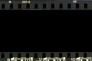 Real film border strip scan and old texture frame and isolated black space. photo