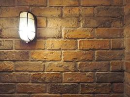 Brick wall old dirty texture background and hanging lamp and yellow light and flare in to camera. photo