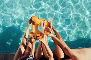 Top view of group of young happy people that have fun in swimming pool at daytime photo