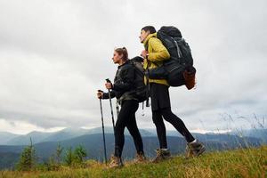 Hiking together. Woman and man. Majestic Carpathian Mountains. Beautiful landscape of untouched nature photo