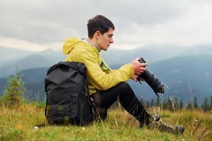 Young photographer makes photos. Majestic Carpathian Mountains. Beautiful landscape of untouched nature photo