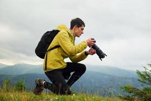 Young photographer makes photos. Majestic Carpathian Mountains. Beautiful landscape of untouched nature photo