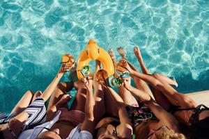 Top view of group of young happy people that have fun in swimming pool at daytime photo