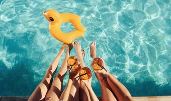 Top view of group of young happy people that have fun in swimming pool at daytime photo