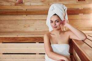 Young beautiful woman have a rest in the sauna. Conception of bodycare photo