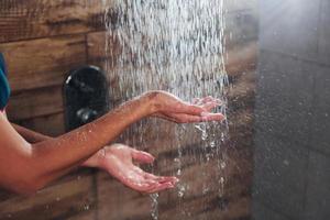 Close up view of hands of woman that taking a shower in spa photo