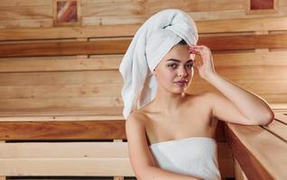 Young beautiful woman have a rest in the sauna. Conception of bodycare photo