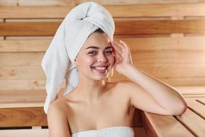 Young beautiful woman have a rest in the sauna. Conception of bodycare photo