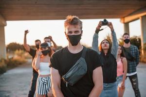 Guy at the front of crowd. Group of protesting young people that standing together. Activist for human rights or against government photo