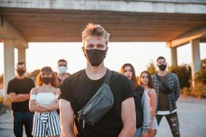 Guy at the front of crowd. Group of protesting young people that standing together. Activist for human rights or against government photo