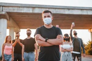 Guy at the front of crowd. Group of protesting young people that standing together. Activist for human rights or against government photo