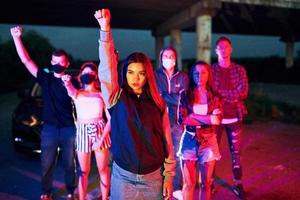 At night time. Group of protesting young people that standing together. Activist for human rights or against government photo