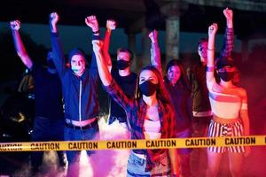 humo, puños, policía. grupo de jóvenes que protestan que se unen. activista por los derechos humanos o contra el gobierno foto