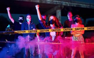 Smoke, fists, police. Group of protesting young people that standing together. Activist for human rights or against government photo