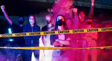 Smoke, fists, police. Group of protesting young people that standing together. Activist for human rights or against government photo