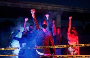 Night of riot. Group of protesting young people that standing together. Activist for human rights or against government photo