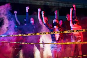 Smoke, fists, police. Group of protesting young people that standing together. Activist for human rights or against government photo